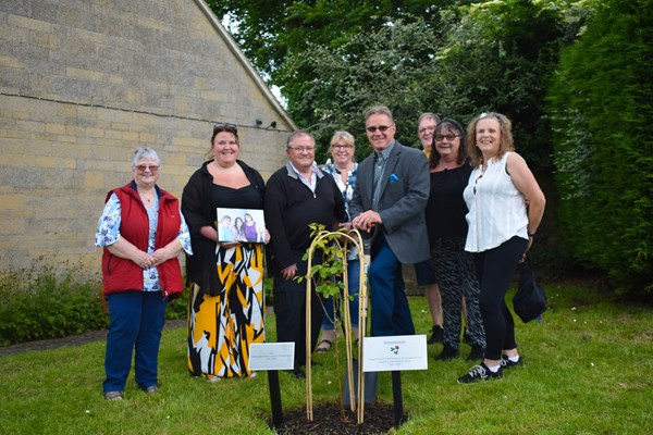 Members of Heather's family plant a rose in her memory at Heather View