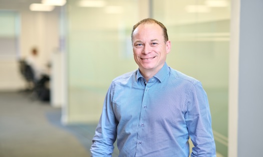 Head and shoulders photograph of a Bromford colleague in an office