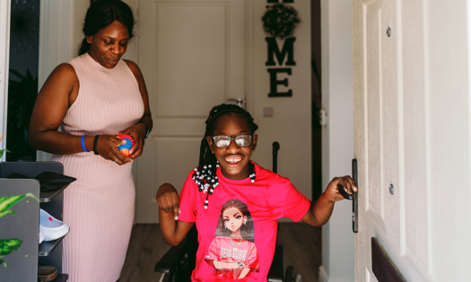 A girl in a wheelchair with her mum 