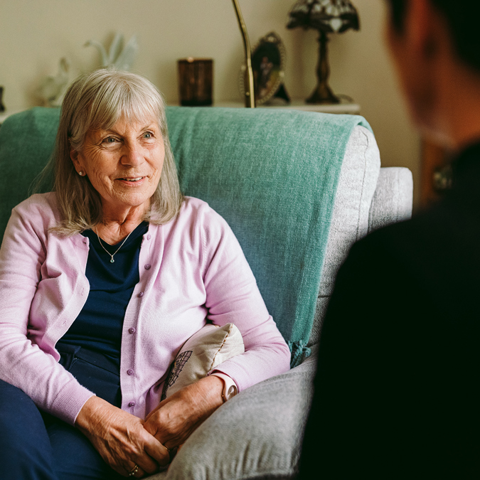 a bromford customer talking to their neighbourhood coach in their lounge