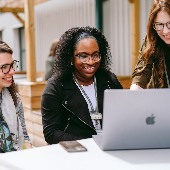 Three bromford colleagues looking at a laptop