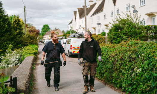 two Bromford colleagues walking on a path 