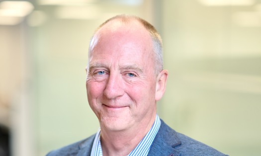 Head and shoulders photograph of a Bromford board member in an office