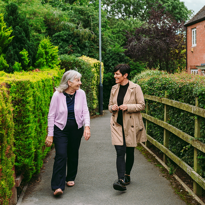 a bromford neighbourhood coach talking to a customer, while walking in their local community