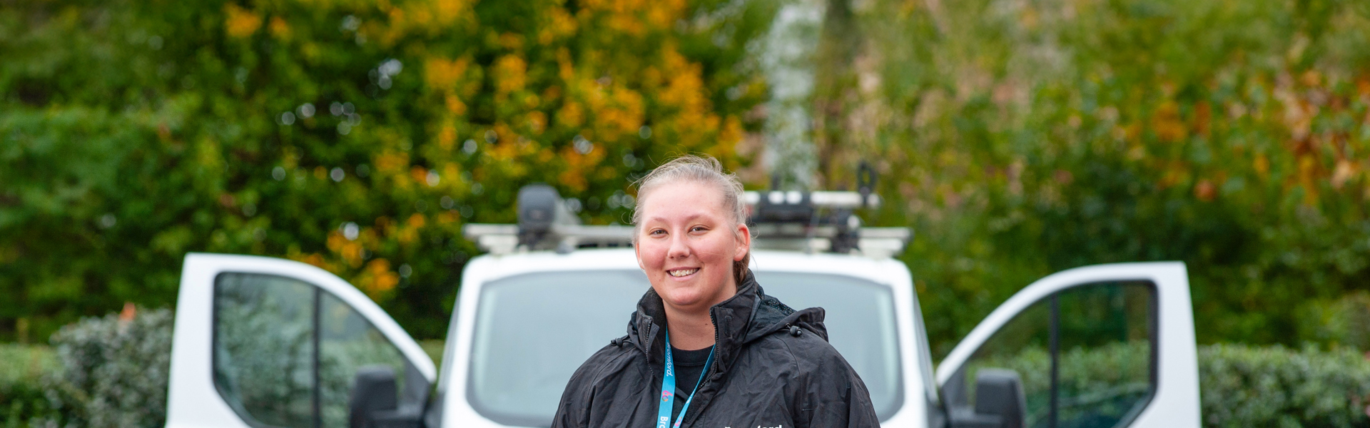 Ebony Hawker holding tools in front of her van