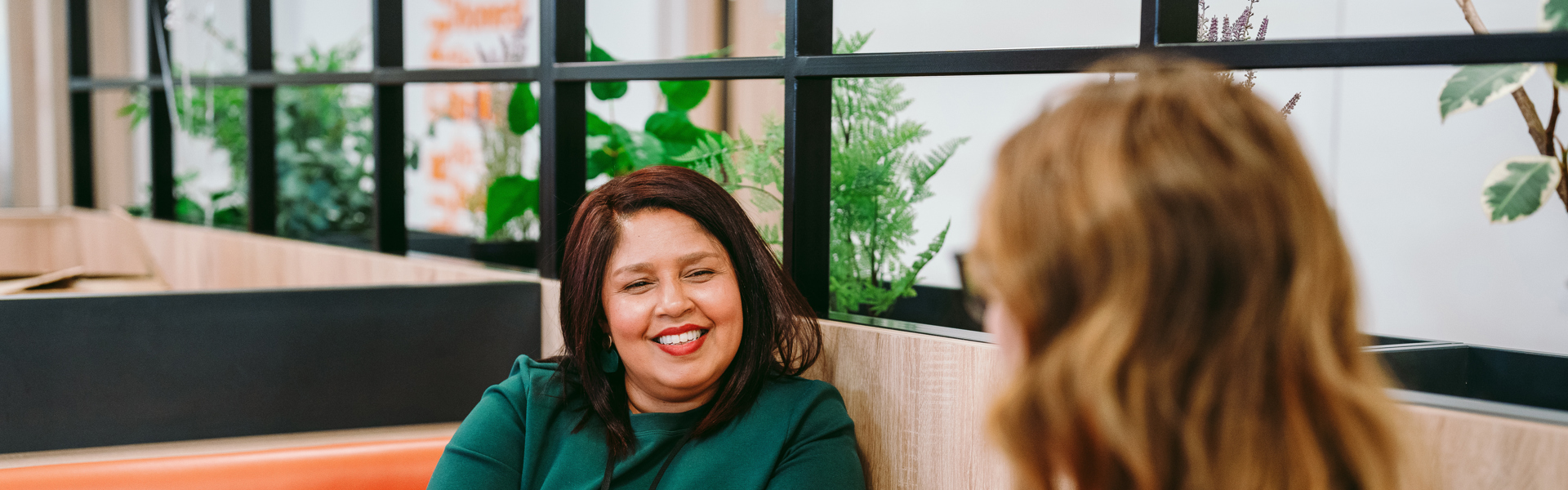 2 women talking across a table