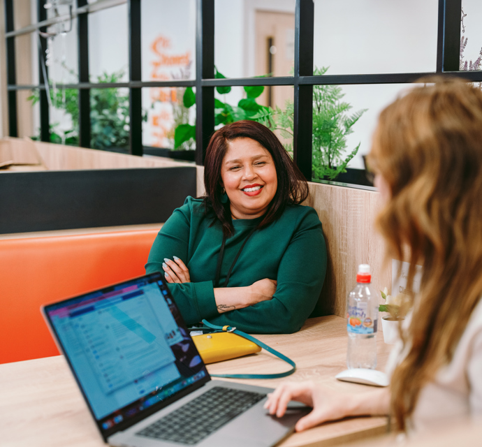 2 women talking across a table