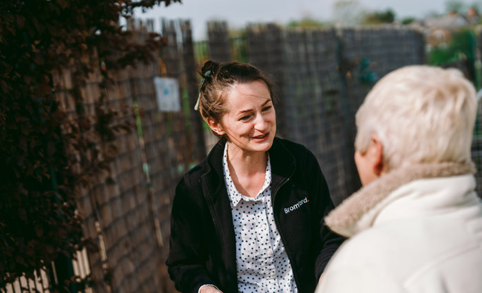  a Bromford colleague and a customer talk with each other