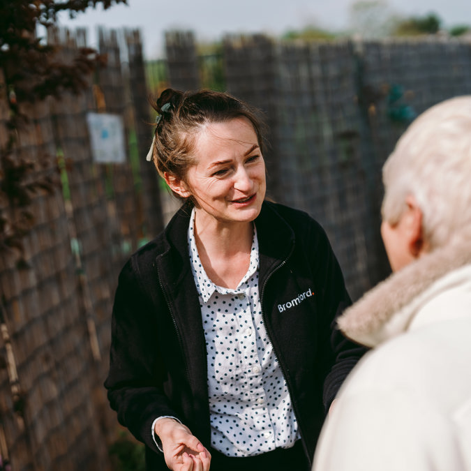  a Bromford colleague and a customer talk with each other