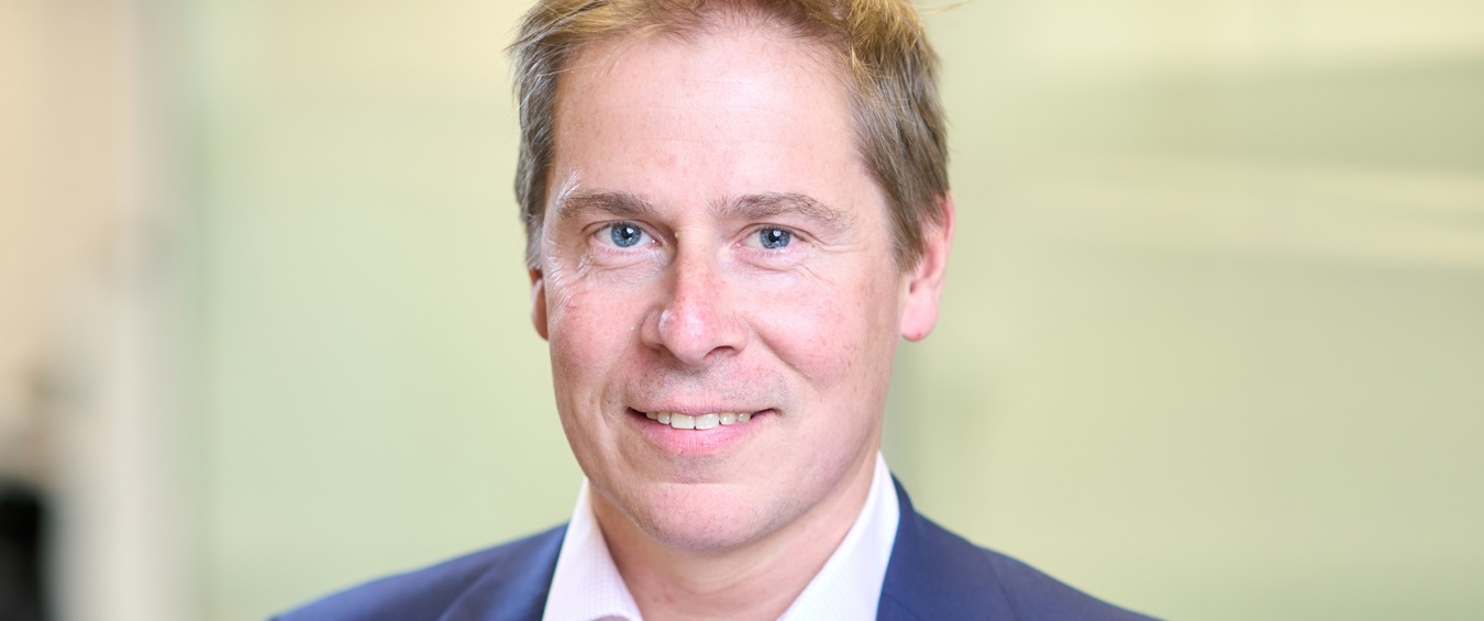 Head and shoulders photograph of a Bromford's chief executive Robert Nettleton in an office