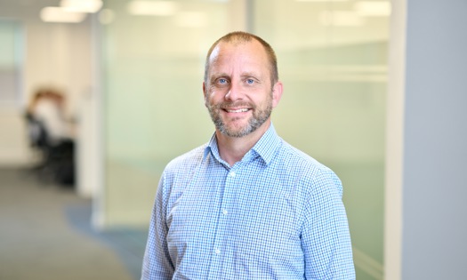 Head and shoulders photograph of a Bromford colleague in an office