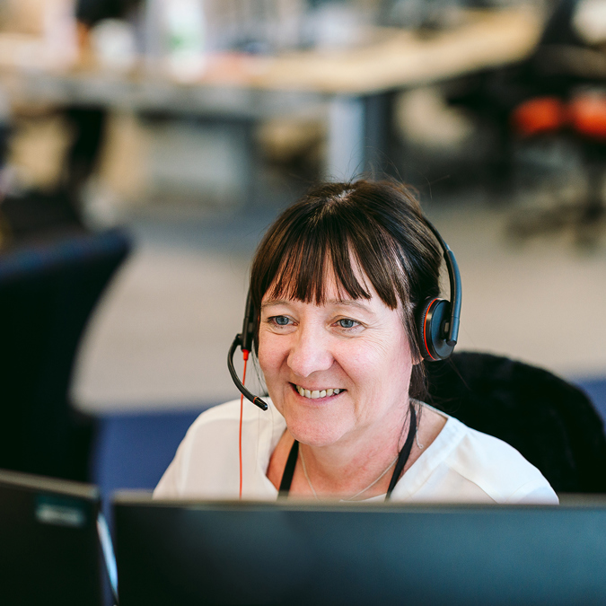 A Bromford customer services colleague using a headset to talk to customers