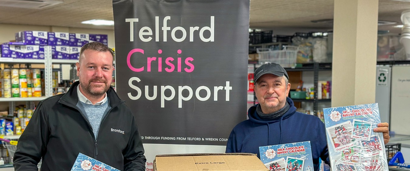 Two people holding advent calendars at Telford foodbank  