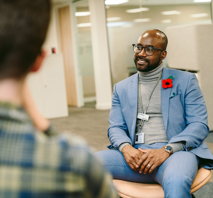 a bromford colleague sitting in an office, talking