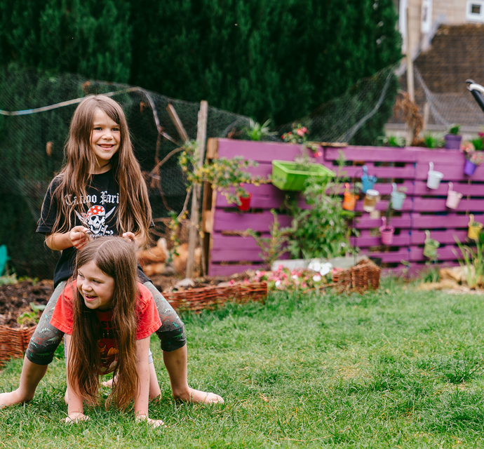 children playing in the garden of their bromford home